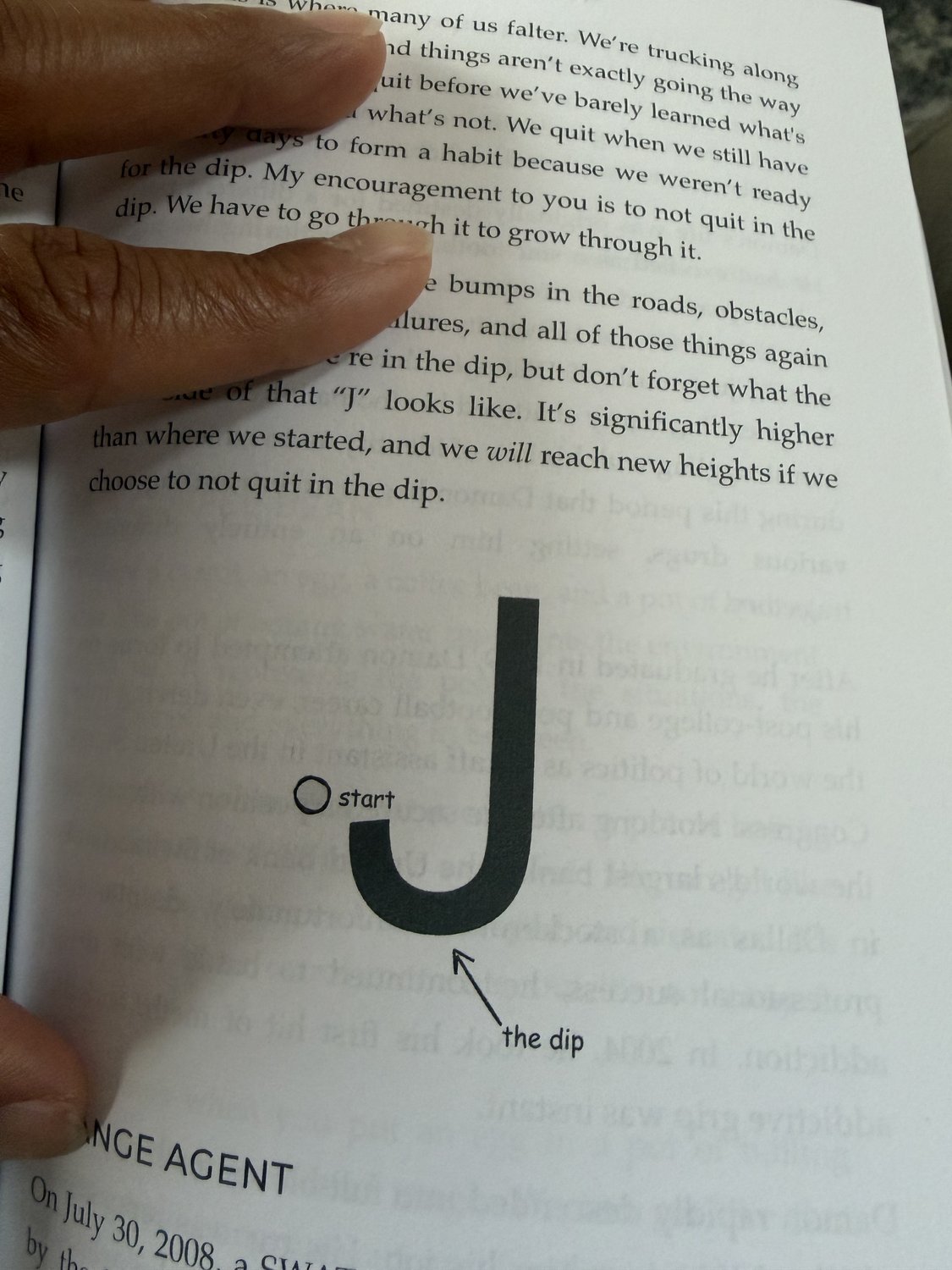 The same J curve, drawn by hand in the book, with the start and the dip marked.