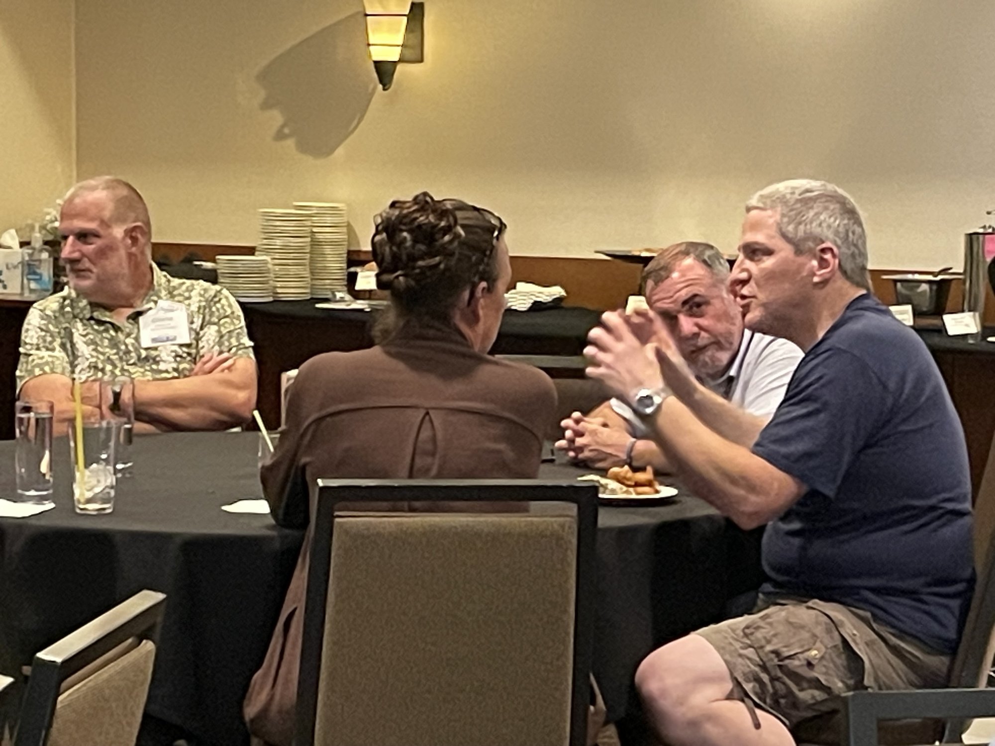 Shop owners deep in conversation between sessions